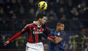 AC Milan's De Sciglio jumps for the ball with Inter Milan's Guarin during their Italian Serie A soccer match in Milan
