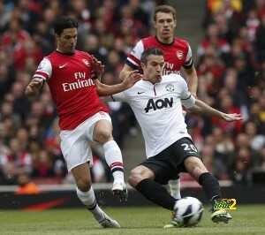 Manchester United's Robin van Persie challenges Arsenal's Mikel Arteta during their English Premier League soccer match at Emirates Stadium in north London