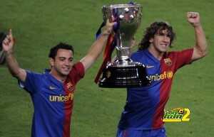 Barcelona's players Carles Puyol (R) and