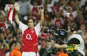 Robert Pires holds the FA Cup aloft as h