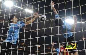 Uruguay's striker Luis Suarez (L) stops