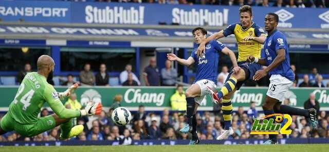 Arsenal's Giroud is challenged by Everton's Distin and Baines as Howard saves his shot during their English Premier League soccer match at Goodison Park in Liverpool