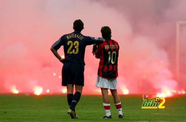 Inter Milan's Materazzi and Rui Costa of AC Milan wait on the pitch during their Champions League soccer match in Milan