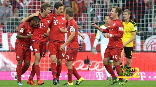 Bayern Munich's Brazilian midfielder Douglas Costa, Bayern Munich's striker Thomas Mueller, Bayern Munich's Polish striker Robert Lewandowski , Bayern Munich's defender Philipp Lahm and Bayern Munich's midfielder Mario Goetze celebrate after the first goal for Munich during the German first division Bundesliga football match FC Bayern Munich vs Borussia Dortmund in Munich, southern Germany, on October 4, 2015.  AFP PHOTO / CHRISTOF STACHE...RESTRICTIONS: DURING MATCH TIME: DFL RULES TO LIMIT THE ONLINE USAGE TO 15 PICTURES PER MATCH AND FORBID IMAGE SEQUENCES TO SIMULATE VIDEO. .== RESTRICTED TO EDITORIAL USE ==.FOR FURTHER QUERIES PLEASE CONTACT DFL DIRECTLY AT + 49 69 650050.        (Photo credit should read CHRISTOF STACHE/AFP/Getty Images)