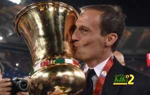 Juventus' coach from Italy Massimiliano Allegri kisses the trophy after winning the Italian Tim Cup final football match AC Milan vs Juventus on May 21, 2016 at the Olympic Stadium in Rome. Juventus won 0-1 in the extra time. AFP PHOTO / TIZIANA FABI