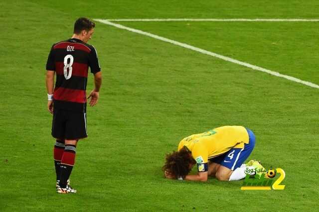 BELO HORIZONTE, BRAZIL - JULY 08: David Luiz of Brazil reacts after being defeated 7-1 by Germany as Mesut Oezil of Germany looks on during the 2014 FIFA World Cup Brazil Semi Final match between Brazil and Germany at Estadio Mineirao on July 8, 2014 in Belo Horizonte, Brazil. (Photo by Jamie McDonald/Getty Images)