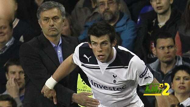 Real Madrid's head coach Jose Mourinho helps Tottenham Hotspur's Gareth Bale back onto the pitch during their Champions League quarterfinal second leg soccer match at White Hart Lane, London, Wednesday, April 13, 2011. (AP Photo/Alastair Grant)